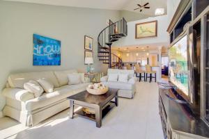 a living room with a couch and a table at 512 Seascape by AvantStay Oceanfront Condo on the Beach Community Pool Access in Isle of Palms