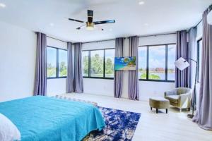 a bedroom with a blue bed and windows at Club House 305 w PRIVATE NIGHTCLUB, Cinema, Game Room, Gym & Pool in Miami +53 photos