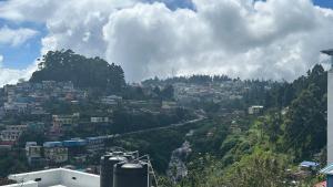 una vista de una ciudad en una colina en Cloudy Vista Kodai, en Kodaikanal 18 fotos más
