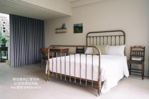 a bedroom with a bed and a desk at Chulin Homestay in Tainan
