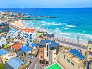 an aerial view of a city and the beach at Jeju eseutteuleya pension in Jeju +3 photos