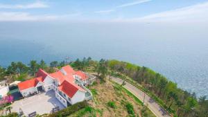 an overhead view of a house next to the water at Namhae baramundeok Pension in Namhae +8 photos