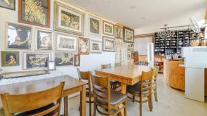 a dining room with a table and some pictures on the wall at Namhae baramundeok Pension in Namhae