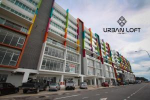 a large building with cars parked in front of it at Urban Loft 17 in Tanjong Aru +4 photos