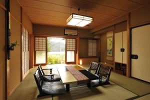 a dining room with a table and chairs at 山魚亭 in Izunokuni