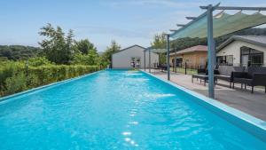 a swimming pool with blue water in a house at Gapyeong meong Valley pension in Gapyeong +19 photos