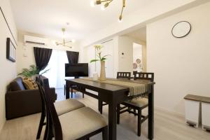 a living room with a dining room table and chairs at Li Kotohogi 302 in Naha +39 photos