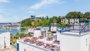 a view from the rooftop of a building with tables and chairs at Samcheok jangho sanho Pension in Samcheok