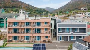 an aerial view of a building with solar panels at yeosu moranggee pension in Yeosu