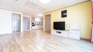 a large living room with a flat screen tv at yeosu moranggee pension in Yeosu