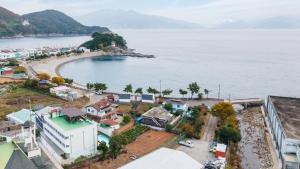 an aerial view of a town next to a body of water at yeosu moranggee pension in Yeosu