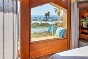 a bedroom with a window with a view of the ocean at Jeju sunjinhanga Pension in Seogwipo