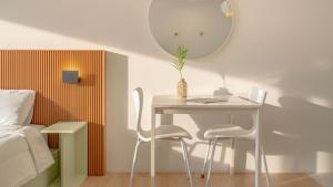 a table and chairs in a bedroom with a mirror at Gapyeong Rowa River view Pension in Gapyeong