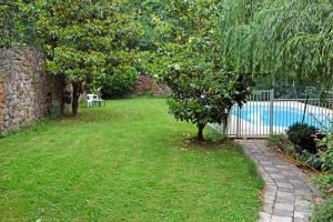 a garden with an apple tree next to a fence at Château Lou Cante Perdrix in La Vernarède +37 photos