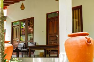 a large orange vase sitting in front of a house at Hiri Point Villa in Dickwella