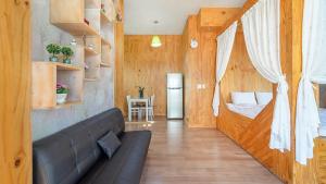 a living room with a couch and a bedroom at Ganghwa Herb Pension in Incheon