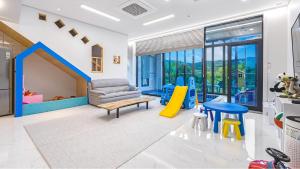 a living room with a couch and a slide at Gyeongju cheongun28 kids Poolvilla in Gyeongju