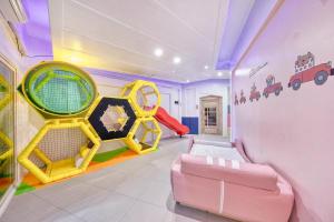a play room with a slide and a couch at Gapyeong Pogny Kids Poolvilla in Gapyeong +18 photos