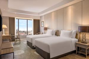 Dusit Princess Melaka客房内的一张或多张床位