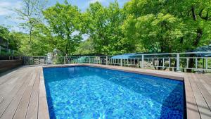 a swimming pool on a deck next to a fence at Gapyeong Wood Valley Kids Pension in Gapyeong