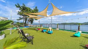 a backyard with a playground with a large tent at Namhae Spring, Summer, Fall, Winter Pet- in Namhae