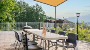 a table with chairs and an umbrella on a patio at Gapyeong Yeonkkocchosu Pet Pension in Gapyeong +4 photos