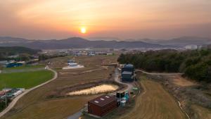 an aerial view of a farm at sunset at Gyeongju Jayeon Pension in Gyeongju