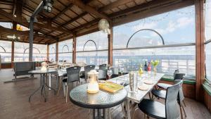 a restaurant with tables and chairs and a large window at Gangwha Jeongwon Pension in Incheon