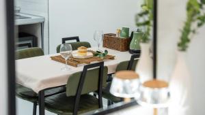 a dining room table with wine glasses on it at Gyeongju Modern Pool Villa in Gyeongju