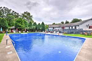 an image of a swimming pool in front of a house at Harmony Ridge by AvantStay Fireplace Large Deck Forest Views in Lake Harmony