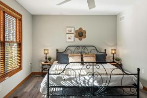 a bedroom with a black metal bed in a room at Lakers Pointe by AvantStay Lakefront Private Peninsula Hot Tub Game Room in Long Pond