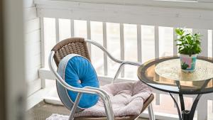 a person sitting in a chair next to a table at Ganghwa Daeun pension in Incheon +2 photos