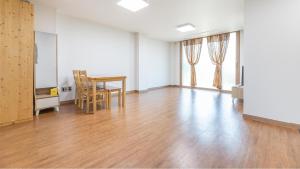 an empty living room with a table and chairs at jeju ondamhouse pension in Jeju +4 photos