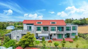 an aerial view of a house with a red roof at jeju ondamhouse pension in Jeju