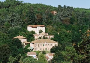 a group of houses on the side of a mountain at Château Lou Cante Perdrix in La Vernarède