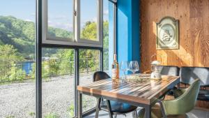 a dining room with a table with wine glasses on it at Gapyeong Villajia Spa Pension in Gapyeong