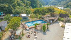 an aerial view of a house with a swimming pool at GaPyeong Yeoldudal Spapension&Camping in Gapyeong