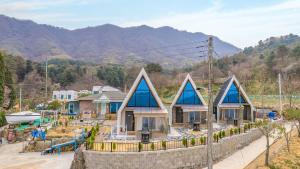 a row of houses with blue roofs on a hill at Gapyeong The Paran Private Pool Villa in Gapyeong +15 photos