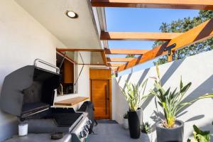 an outdoor patio with plants and a wooden door at Edwin by AvantStay Hollywood Hills Luxury Pool in Los Angeles