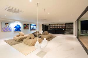 a living room with two couches and a chandelier at Villa ME Huge and Luxurious villa in Ban Thong Phlu