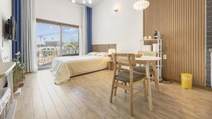 a bedroom with a bed and a desk and a table at Chuncheon Lio Pension in Chuncheon