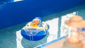 a baby in an inner tube in a swimming pool at Pocheon luxjay pet Pension in Pocheon +12 photos