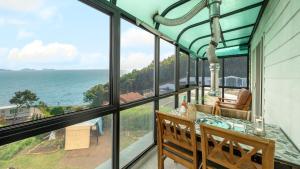 a dining room with a view of the ocean at Ganghwa White Stone Pension in Incheon