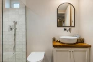 a bathroom with a sink and a shower at Ilyessa Cottages in Méson Yerakaríon +60 photos