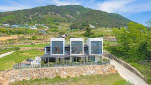 an aerial view of a house on a hill at Namhae Ourpoolvilla in Namhae