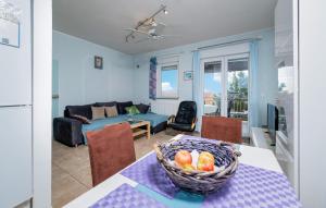 a living room with a table with a basket of fruit on it at Beautiful Apartment In Barbariga in Barbariga