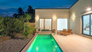 a swimming pool in the backyard of a house at Jeju stay eden Dokche poolvila Pension in Seogwipo +3 photos