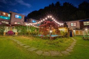 a house with lights in the yard at night at Gapyeong Swimteo Pet Pension in Gapyeong +4 photos