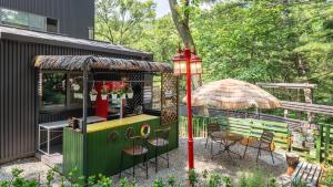 a playground with a table and chairs and an umbrella at gwangju chez pompom dokchae poolvilla in Gwangju