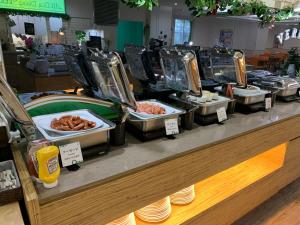 a buffet line with different types of food on display at ANA Holiday Inn Sapporo Susukino by IHG in Sapporo